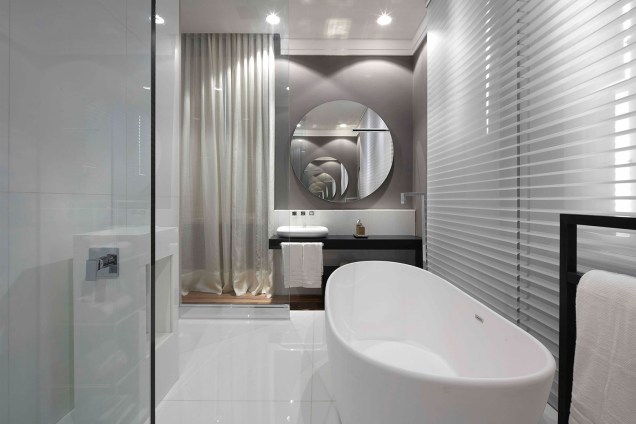 <span><strong>Suíte Essencial</strong> - CR Studio. Na área do banho da suíte, as paredes são neutras e ganham cortinas de linho e persianas, que garantem um estilo clean e contemporâneo.</span>