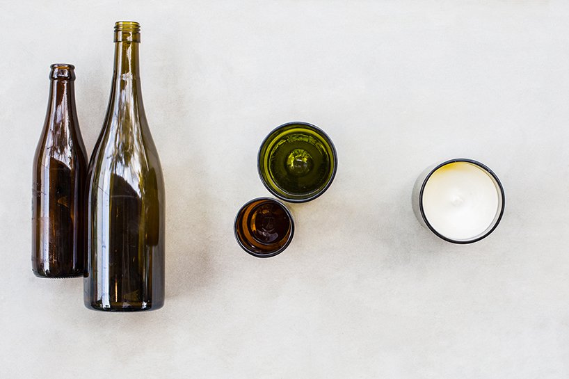 Velas de vidro feitas a partir de garrafas de vinho cortadas, que queimam bio-cera criada a partir do óleo de cozinha usado no próprio restaurante.
