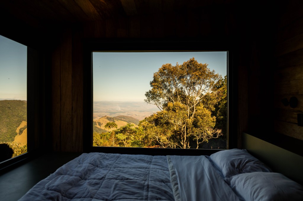 Tiny house sustentável fica a 1500 m de altitude na região serrana de SP. Projeto de Ricardo Delgallo. Na foto, quarto com vista para as montanhas.